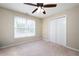 Bright, empty bedroom featuring carpet, neutral color walls, a window, and a large double-door closet at 138 Knightwood Pt, Acworth, GA 30101