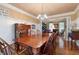 Elegant dining room with a large wooden table, seating for eight, and views into the living room at 138 Knightwood Pt, Acworth, GA 30101