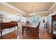 Traditional dining room with hardwood floors, paneled walls, and a wooden table with six chairs at 138 Knightwood Pt, Acworth, GA 30101