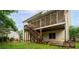 Back exterior view shows the screened porch, patio, and staircase access to the outdoor space at 138 Knightwood Pt, Acworth, GA 30101