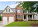 Charming two-story brick home with a well-manicured lawn and attached two-car garage at 138 Knightwood Pt, Acworth, GA 30101