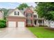 Charming two-story brick home with a well-manicured lawn and attached two-car garage at 138 Knightwood Pt, Acworth, GA 30101