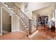 Elegant foyer with hardwood floors, stairs, and wrought iron railing at 138 Knightwood Pt, Acworth, GA 30101