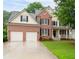 Inviting two-story home with brick and siding, showcasing a well-kept lawn and front porch at 138 Knightwood Pt, Acworth, GA 30101