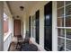 Inviting front porch with classic columns and rocking chairs at 138 Knightwood Pt, Acworth, GA 30101