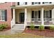 Inviting front porch with classic columns and rocking chairs at 138 Knightwood Pt, Acworth, GA 30101