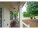 Inviting front porch with classic columns and rocking chairs at 138 Knightwood Pt, Acworth, GA 30101
