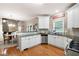 Spacious kitchen with granite countertops, white cabinets, and stainless steel appliances open to dining area at 138 Knightwood Pt, Acworth, GA 30101