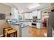 Bright kitchen featuring white cabinetry, granite countertops, stainless steel appliances, and a breakfast bar at 138 Knightwood Pt, Acworth, GA 30101