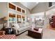 Inviting living room with open access to kitchen, large windows, neutral decor, and direct access to a screened porch at 138 Knightwood Pt, Acworth, GA 30101