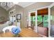 Comfortable living space with a view to the screened-in porch through sliding doors, and a dining table with seating at 138 Knightwood Pt, Acworth, GA 30101
