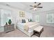 Primary bedroom featuring white trim, a ceiling fan, a bench, and bright natural light at 138 Knightwood Pt, Acworth, GA 30101