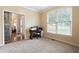 Cozy office space featuring a large window, carpet, and unique sliding barn door at 138 Knightwood Pt, Acworth, GA 30101