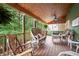 Relaxing screened porch with ceiling fan, comfortable wicker furniture, and serene views of the lush backyard at 138 Knightwood Pt, Acworth, GA 30101