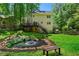 Expansive backyard offers a decorative pond, lawn, and deck on home's exterior at 1769 Milford Creek Sw Cts, Marietta, GA 30008