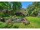 Well-maintained backyard features a tranquil pond, lush lawn, and deck on house at 1769 Milford Creek Sw Cts, Marietta, GA 30008