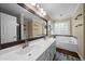 Large bathroom boasts double sink vanity, garden tub, and updated fixtures at 1769 Milford Creek Sw Cts, Marietta, GA 30008