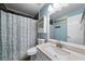 Bathroom with updated vanity, shower with blue patterned curtain, and tiled floors at 1769 Milford Creek Sw Cts, Marietta, GA 30008