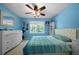 Bright blue bedroom with natural light, white dresser, and hardwood floors at 1769 Milford Creek Sw Cts, Marietta, GA 30008