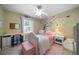 Neutral bedroom with decorative tree art, charming furniture, and pink accents at 1769 Milford Creek Sw Cts, Marietta, GA 30008
