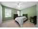 Comfortable bedroom with neutral carpet features natural light and minimal furniture at 1769 Milford Creek Sw Cts, Marietta, GA 30008