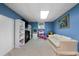 Bright blue bonus room offers neutral carpet, white couch, and a play area at 1769 Milford Creek Sw Cts, Marietta, GA 30008