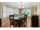 Formal dining room featuring hardwood floors, elegant chandelier, and plantation shutters at 1769 Milford Creek Sw Cts, Marietta, GA 30008