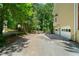 Spacious driveway leading to a two-car garage and a basketball court, surrounded by mature trees and landscaping at 1769 Milford Creek Sw Cts, Marietta, GA 30008