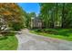 Traditional two-story home with a brick facade, well-manicured lawn, and a long driveway lined with trees at 1769 Milford Creek Sw Cts, Marietta, GA 30008