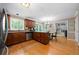Open kitchen and dining area with wood floors, cherry cabinets, granite countertops, and stainless appliances at 1769 Milford Creek Sw Cts, Marietta, GA 30008