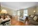 Comfortable living room with hardwood floors, large windows, and a stylish white piano at 1769 Milford Creek Sw Cts, Marietta, GA 30008