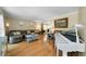 Cozy living room with hardwood floors, neutral decor, and a white grand piano at 1769 Milford Creek Sw Cts, Marietta, GA 30008