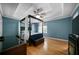 Blue walled main bedroom boasts tray ceiling, ceiling fan, and draped canopy bed at 1769 Milford Creek Sw Cts, Marietta, GA 30008