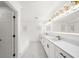 Bright bathroom with long vanity featuring double sinks, white cabinets, marble floors, and modern lighting at 1887 Chedworth Ct, Stone Mountain, GA 30087