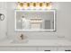 Updated bathroom featuring modern vanity with gold fixtures, quartz countertop, and updated lighting at 1887 Chedworth Ct, Stone Mountain, GA 30087