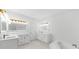Bright bathroom with double vanity, marble floors, white cabinets and gold fixtures at 1887 Chedworth Ct, Stone Mountain, GA 30087