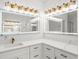 Updated bathroom featuring dual vanities with quartz countertops, updated fixtures, and modern lighting at 1887 Chedworth Ct, Stone Mountain, GA 30087