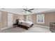Spacious bedroom featuring a ceiling fan, neutral colors, and carpeted floors at 1887 Chedworth Ct, Stone Mountain, GA 30087