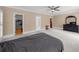 Open bedroom with neutral walls, plush carpet, ceiling fan, and access to a walk-in closet at 1887 Chedworth Ct, Stone Mountain, GA 30087