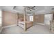 Bedroom with a four-poster bed, ceiling fan, and neutral paint at 1887 Chedworth Ct, Stone Mountain, GA 30087