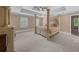 Elegant bedroom with a four-poster bed, ceiling fan, and neutral paint at 1887 Chedworth Ct, Stone Mountain, GA 30087