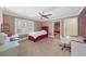 Bedroom with a single bed, ceiling fan, two desks, and natural light from a window at 1887 Chedworth Ct, Stone Mountain, GA 30087