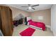 Cozy bedroom with pink accents, a ceiling fan, and built-in shelving for storage at 1887 Chedworth Ct, Stone Mountain, GA 30087