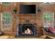 Fireplace featuring ornate wood mantle and tiled surround between bright windows at 1887 Chedworth Ct, Stone Mountain, GA 30087