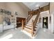 Impressive foyer with a split staircase, marble floors, and soaring ceilings at 1887 Chedworth Ct, Stone Mountain, GA 30087