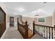 Upstairs hallway featuring wooden railing, neutral paint, carpet and modern lighting at 1887 Chedworth Ct, Stone Mountain, GA 30087