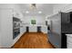 Bright, updated kitchen with stainless appliances, white cabinets, and hardwood flooring at 1887 Chedworth Ct, Stone Mountain, GA 30087