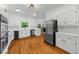 Bright, updated kitchen with stainless appliances, white cabinets, and hardwood flooring at 1887 Chedworth Ct, Stone Mountain, GA 30087