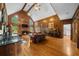 Living room featuring wood paneling, hardwood floors, a fireplace, and natural light at 1887 Chedworth Ct, Stone Mountain, GA 30087