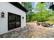 Outdoor patio with stone floor and outdoor seating surrounded by nature at 1887 Chedworth Ct, Stone Mountain, GA 30087
